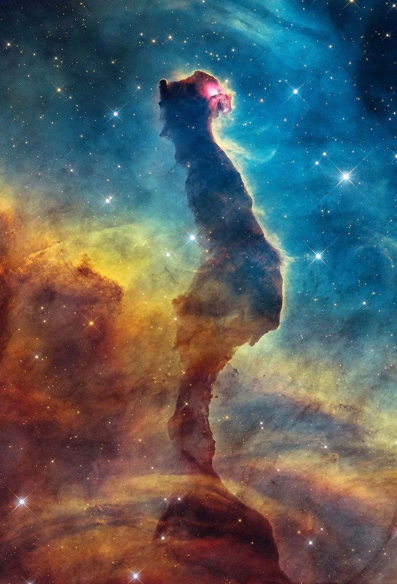 Pilier sombre en forme de chat dans la Carène, bordé de gaz lumineux dans l’observation de Hubble.